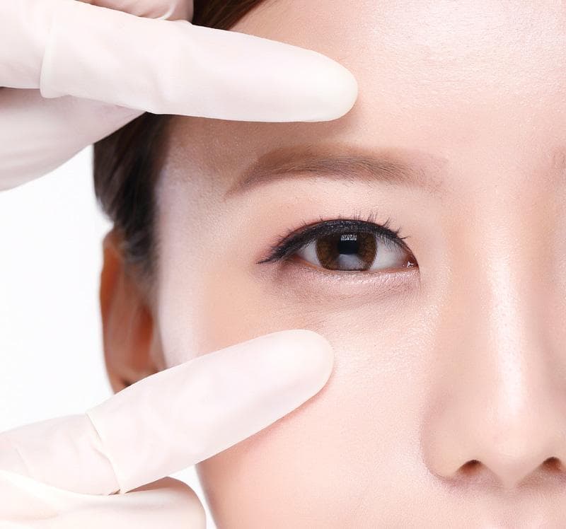 Eye surgery consultation in Korea showing assessment of the outer eye corner.