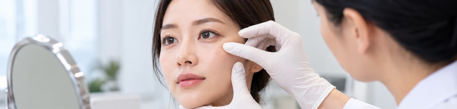 Illustrative lower blepharoplasty consultation assessing under-eye bags and lower-eyelid contours.